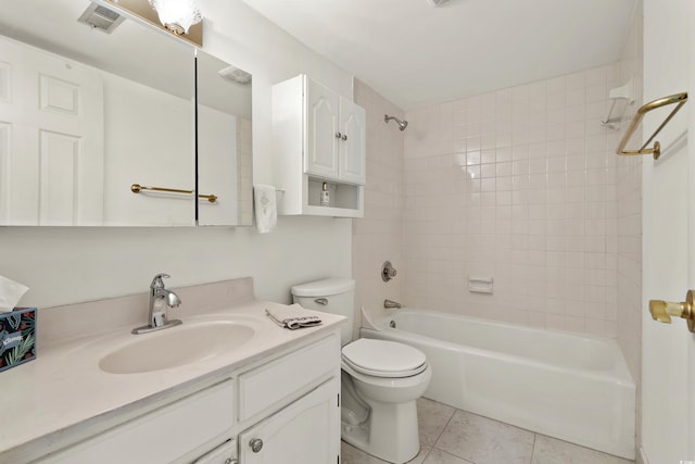 full bathroom with tiled shower / bath combo, vanity, tile patterned floors, and toilet