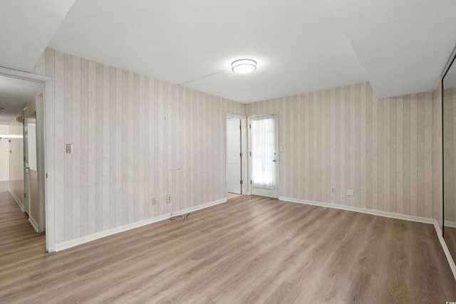 spare room featuring light hardwood / wood-style floors