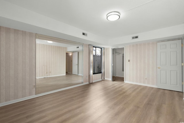 unfurnished room with wood-type flooring