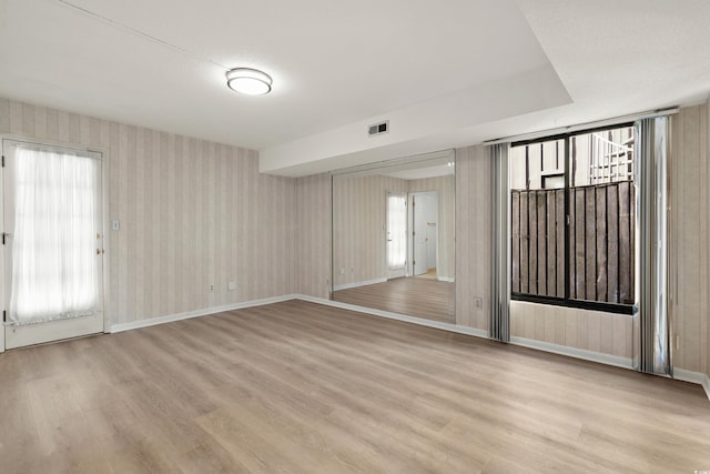 empty room with light hardwood / wood-style floors