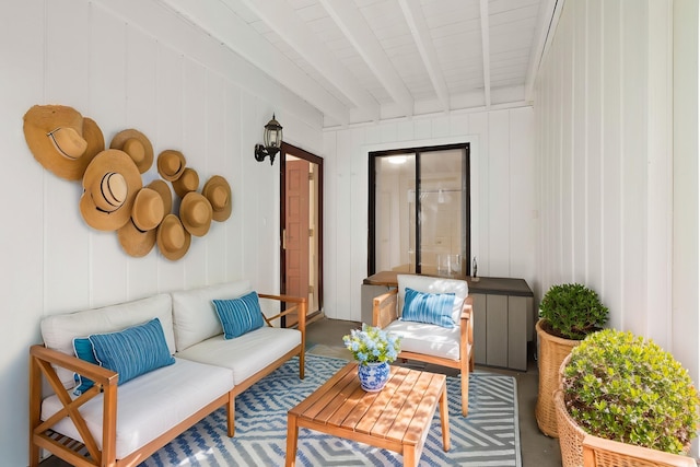 sunroom featuring beamed ceiling