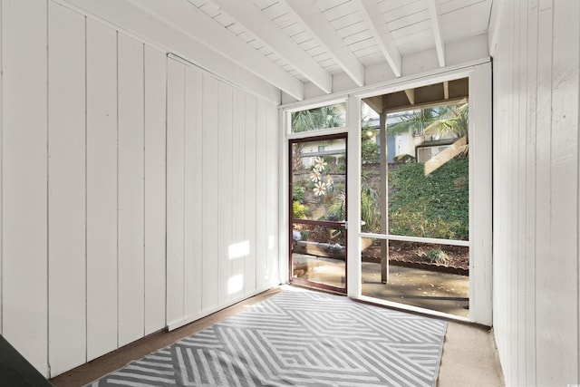 unfurnished sunroom with beam ceiling