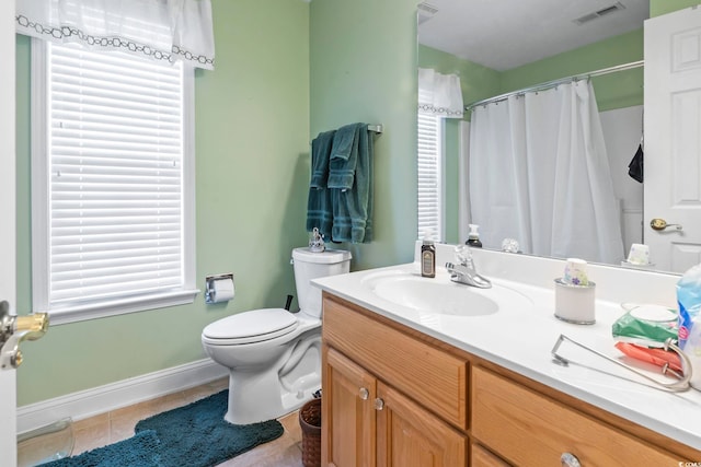 bathroom featuring vanity, toilet, and tile patterned flooring