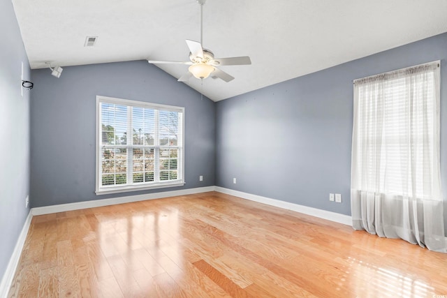 empty room featuring vaulted ceiling, ceiling fan, and light hardwood / wood-style floors