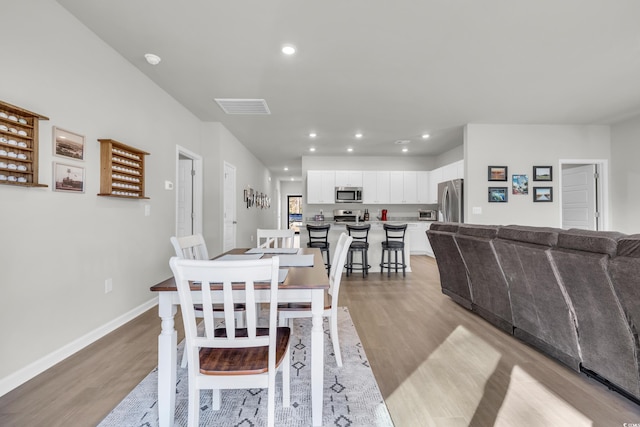 dining space featuring light wood-type flooring