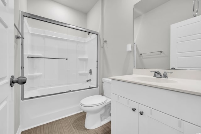 full bathroom featuring toilet, vanity, and enclosed tub / shower combo