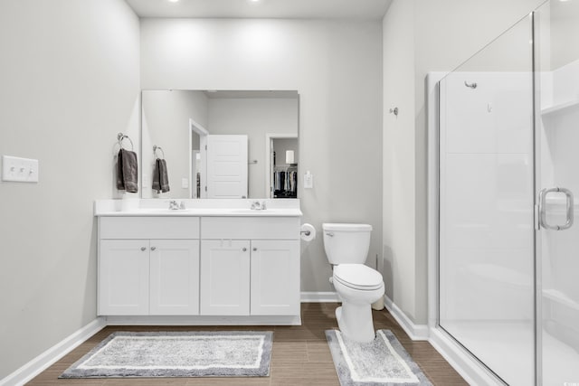 bathroom featuring vanity, walk in shower, and toilet