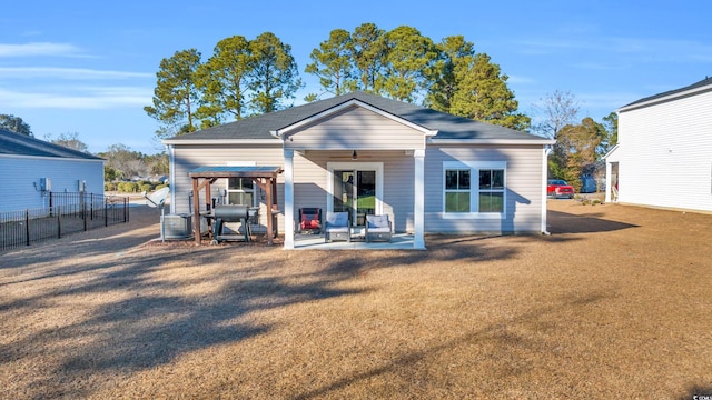 back of house featuring a lawn and a patio area