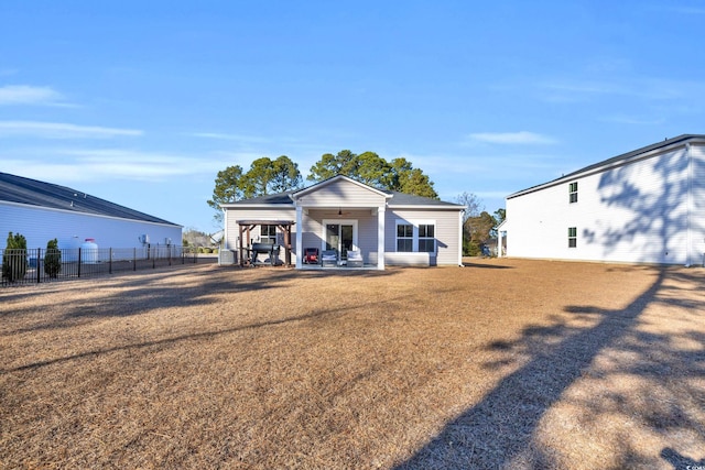 back of property with a patio and a lawn