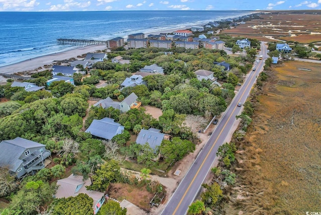 drone / aerial view featuring a water view and a beach view