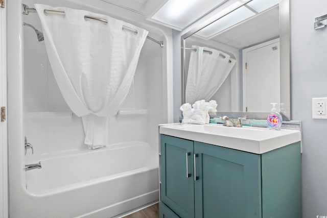 bathroom featuring washtub / shower combination, hardwood / wood-style floors, and vanity