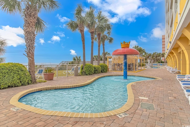 view of pool with pool water feature and a patio area