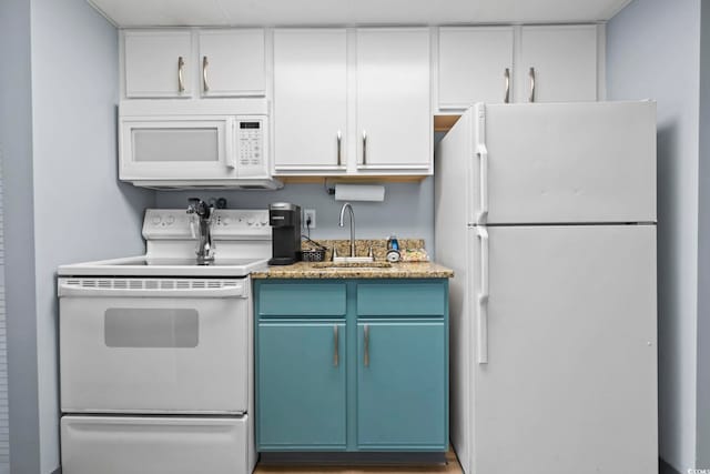 kitchen with white cabinets, white appliances, sink, and blue cabinets