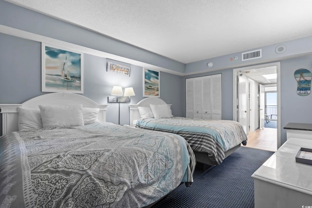 bedroom featuring a textured ceiling and a closet