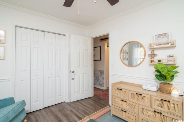 bedroom with ceiling fan, hardwood / wood-style flooring, a closet, and ornamental molding