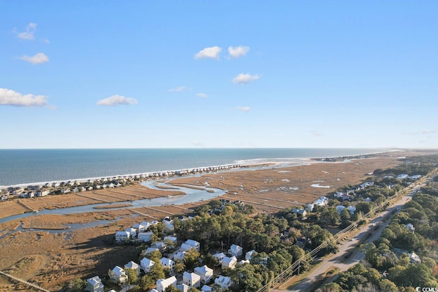 birds eye view of property with a water view and a beach view