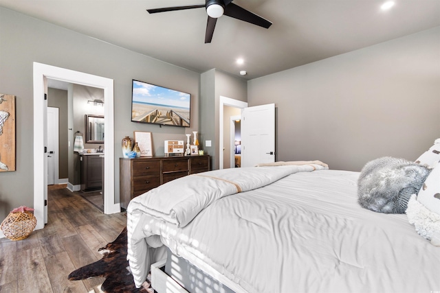 bedroom featuring ceiling fan, ensuite bathroom, and dark hardwood / wood-style floors