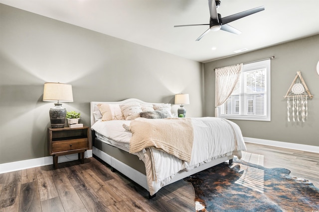 bedroom with dark hardwood / wood-style floors and ceiling fan