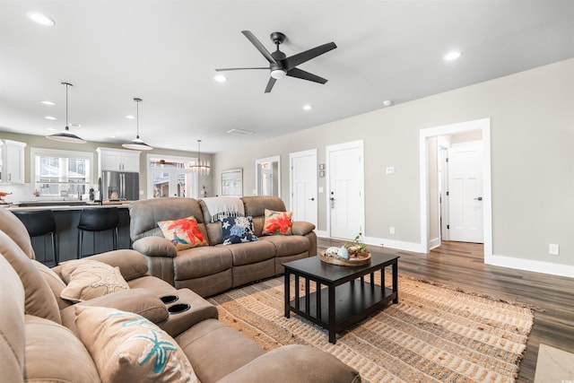 living room with ceiling fan and light hardwood / wood-style floors