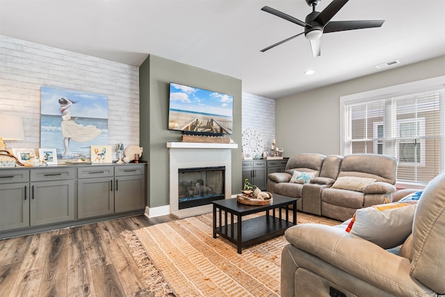 living room featuring ceiling fan and light hardwood / wood-style flooring