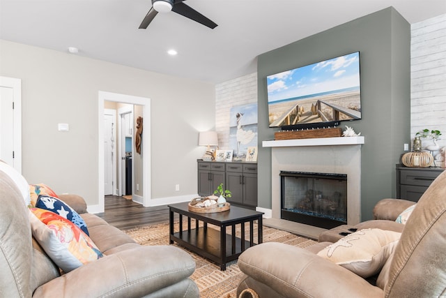 living room featuring hardwood / wood-style floors and ceiling fan