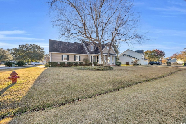 cape cod home featuring a front yard