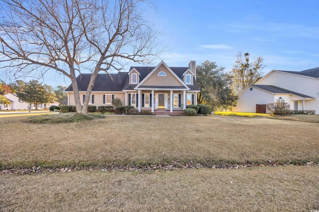 new england style home with a porch and a front yard