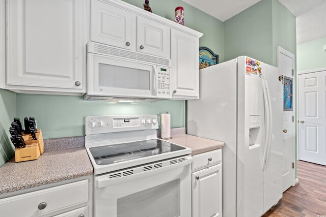 2080 Cross Gate Blvd Unit 303, Surfside Beach, SC 29575 - kitchen featuring white appliances, white cabinets, light countertops, and wood finished floors