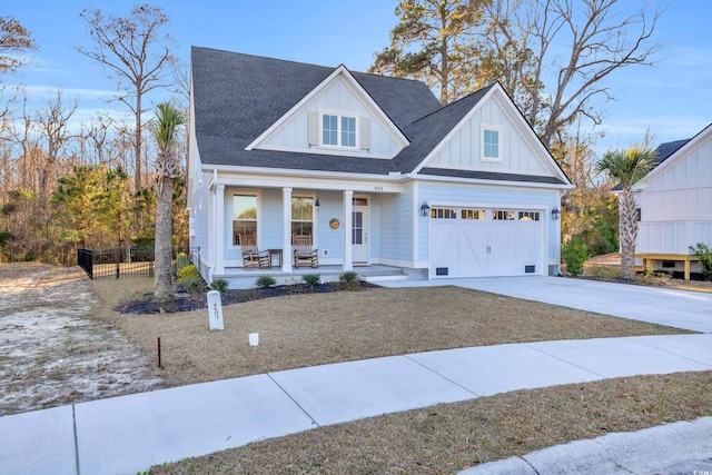 view of front of property with a porch and a garage