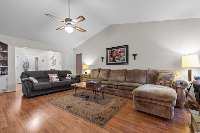 living room featuring hardwood / wood-style flooring, high vaulted ceiling, and ceiling fan