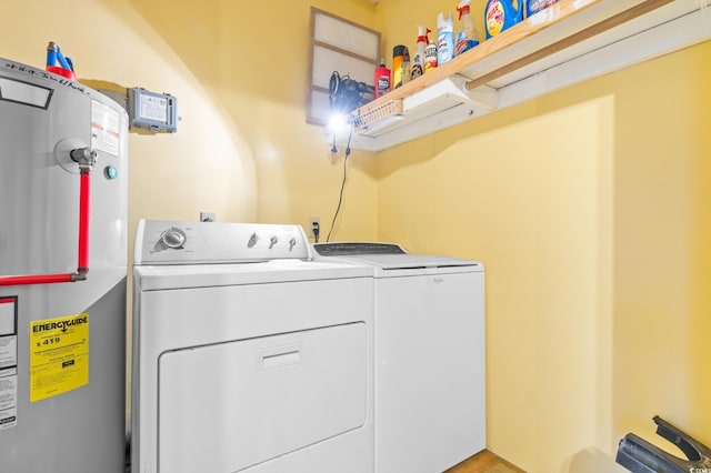 laundry room with washing machine and dryer and water heater