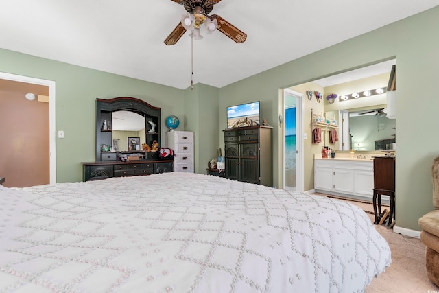 bedroom with light carpet, ceiling fan, and ensuite bathroom