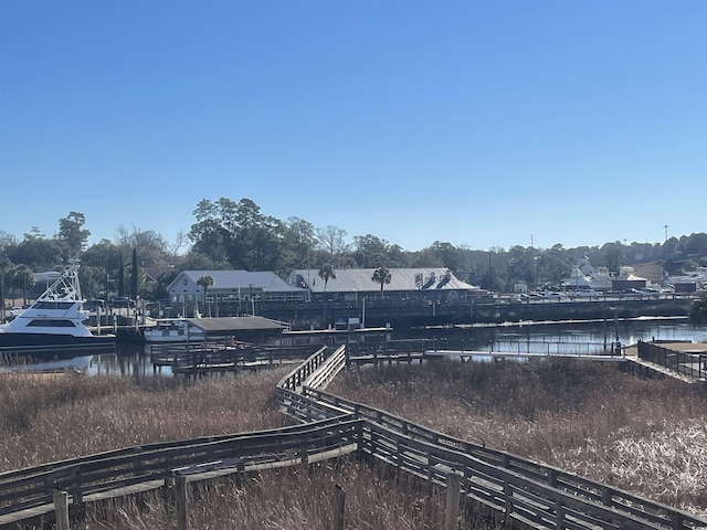 view of yard featuring a water view and fence