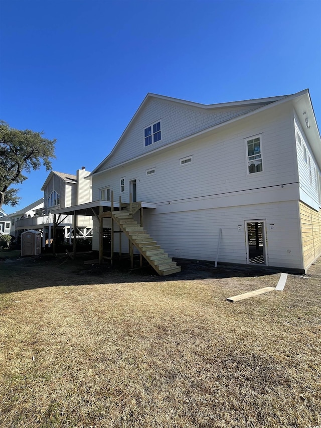 rear view of property featuring stairway