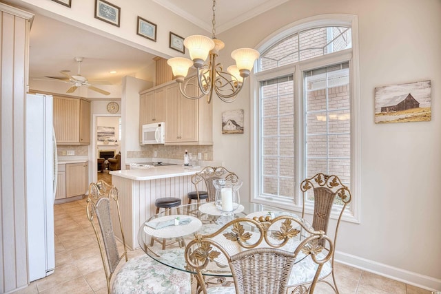 dining room with crown molding, light tile patterned floors, and ceiling fan with notable chandelier