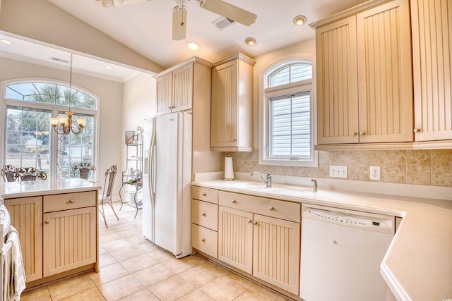 kitchen with sink, tasteful backsplash, vaulted ceiling, white appliances, and ceiling fan with notable chandelier