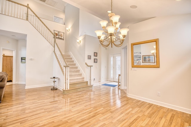 entryway with light hardwood / wood-style flooring and a notable chandelier