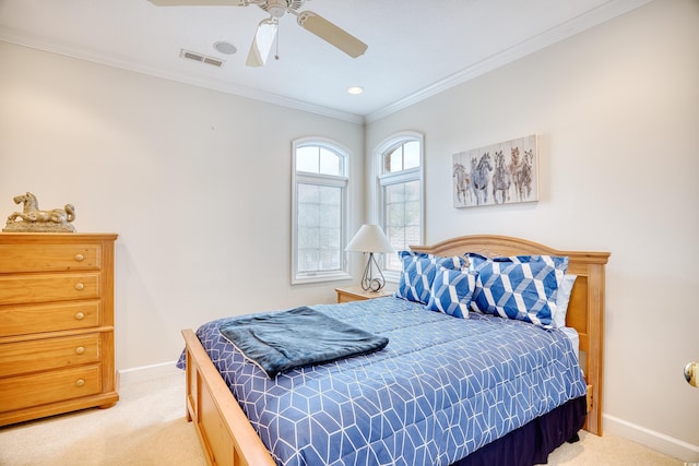 carpeted bedroom featuring ceiling fan and ornamental molding