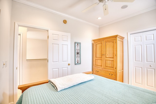 bedroom with ceiling fan, crown molding, and a closet