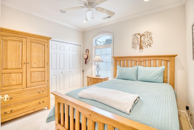 carpeted bedroom featuring ceiling fan, crown molding, and a closet