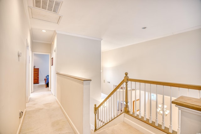 hallway with crown molding and light colored carpet