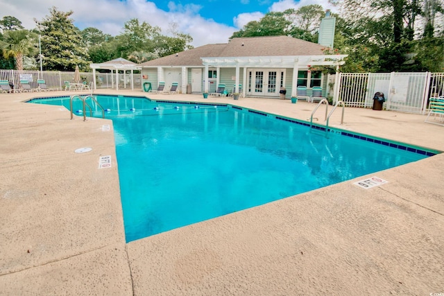 view of swimming pool featuring a gazebo, a patio area, french doors, and a pergola