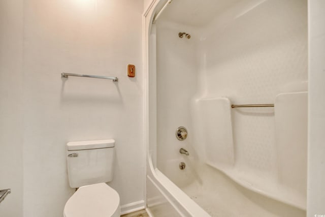 bathroom featuring shower / bathing tub combination and toilet