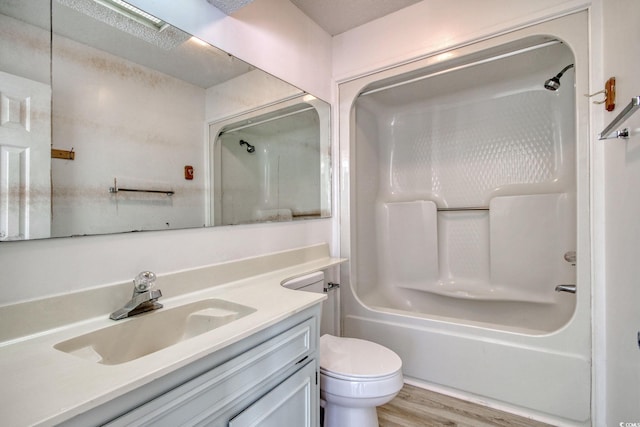 full bathroom with shower / bathtub combination, toilet, vanity, and wood-type flooring