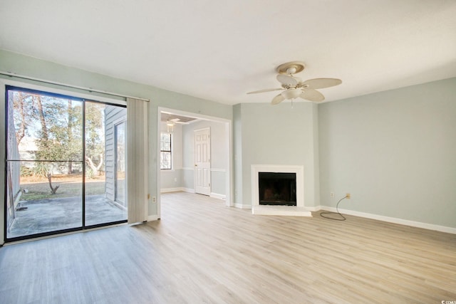 unfurnished living room with ceiling fan and light hardwood / wood-style flooring