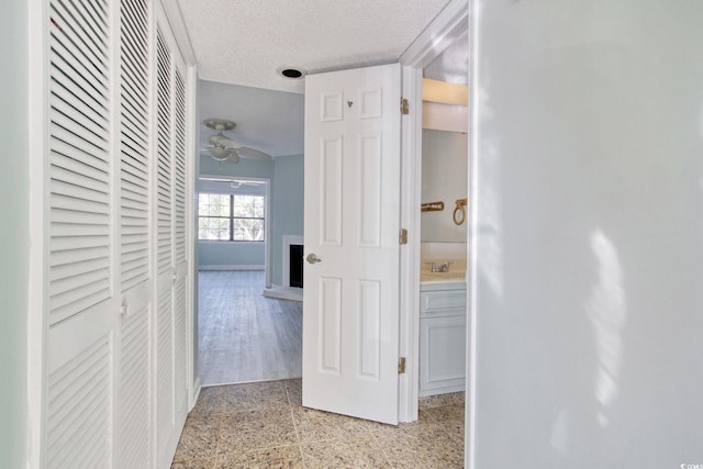 hallway featuring a textured ceiling