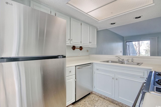 kitchen featuring white cabinets, appliances with stainless steel finishes, and sink