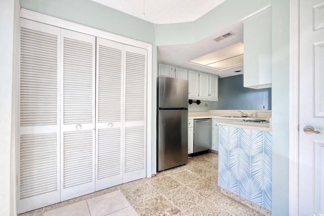 kitchen with stainless steel appliances and white cabinets