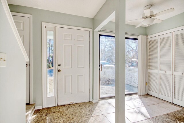 foyer featuring light tile patterned flooring and ceiling fan