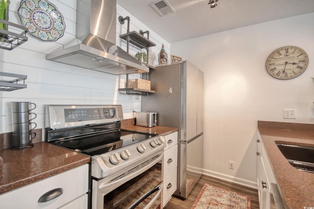 kitchen featuring white cabinetry, dark hardwood / wood-style flooring, stainless steel electric stove, range hood, and sink